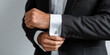 © Artificial South - A man in a black suit adjusts his cuff links