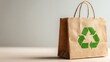 © sitiprapti - Brown paper shopping bag with a green recycling symbol, ecofriendly and sustainable packaging, isolated on a light gray background