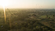 © AmazingAerialAgency - Aerial view of hot air balloons float serenely over ancient temples and lush landscapes bathed in the soft, golden light of dawn, Old Bagan, Mandalay Region, Myanmar.