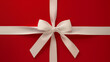 © apimagine - A simple and elegant minimalist design featuring a neatly tied white ribbon bow on a vibrant red background, perfect for festive or gift-themed visuals.