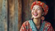 © sambath - A woman in traditional clothing with a colorful headscarf and large earrings, smiling and looking to the side.
