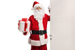 © Ljupco Smokovski - Santa Claus opening a door with a present