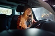 © Drazen - Young happy woman driving her car during winter.