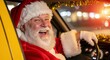 © Tatiana - Santa Claus smiling while driving a yellow taxi at night