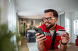 © Migma_Agency - Man shopping online using smartphone and credit card at home