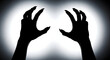 © ismail - Sinister silhouette of monstrous, clawed hands emerging from the darkness, casting an eerie glow, symbolizing fear, threat, and supernatural horror