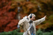 © Zoran Jesic - Young woman dancing freely in autumn park enjoying music