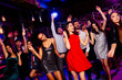 © deagreez - Energetic party crowd dances at vibrant nightclub with stylish guests celebrating together under colorful lights and music at a festive event