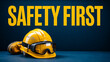 © Adnan Gee - Safety First message with hard hat, goggles and work boot on blue background.