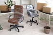 © Pixel-Shot - Interior of office with chairs wrapped in stretch film and cardboard boxes on moving day
