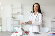 © Pixel-Shot - Adult female doctor with laptop in clinic