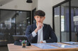 © crizzystudio - Young businessman analyzing financial data and planning strategy