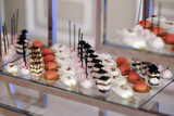 Gourmet miniature desserts with pastel glazes showcased