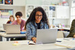 © Rido - Happy smiling african american girl using laptop in class
