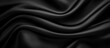 © Mariya - Smooth black silk fabric with gentle flowing folds and a glossy finish conveying elegance and luxury