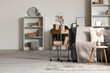 © Pixel-Shot - Stylish interior of living room with grey sofa and shelving units