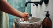 © peopleimages.com - Person, washing and hands with water in bathroom for hygiene, remove germs and bacteria disinfection. Faucet, palm and cleaning skin with antibacterial liquid, sanitation habit and wellness at house