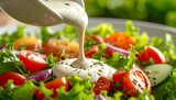 Salad being dressed with creamy dressing. Close-up of fresh ingredients; vibrant colors