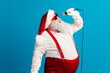 © deagreez - Santa performs on a blue background wearing red suspenders and hat while singing into a microphone for a festive holiday performance