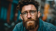© Sanzharstock - Thoughtful redhead man with beard and glasses looking