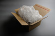 © Jam - Open cardboard box completely filled with transparent bubble wrap showing maximum protective cushioning for safe product shipping and delivery