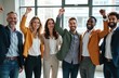 © miss irine - Six diverse business professionals stand together in modern office, smiling, raising fists in celebration. Represent teamwork, success, achievement in corporate environment. Image conveys confidence,