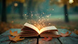 © simohamed - Open book with glowing sparks, autumn leaves on wood table. Story tale magic, fantasy, knowledge, wisdom, imagination, education concept. Mystical mood with blur bokeh light.