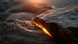 © Bussakon - Dramatic close up of a rough textured rock surface featuring a vivid glowing fissure emitting intense light bathed in warm sunset hues