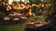 © Emaan Malik - Sleek stainless steel portable BBQ pit set up on a patio surrounded by garden lights and outdoor chairs The image shows grilled steaks and vegetables ready to serve