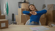 © Krakenimages.com - Woman relaxing in new home surrounded by moving boxes in a bright living room, enjoying a moment during unpacking.