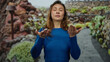 © Krakenimages.com - Woman practicing tai-chi in peaceful park setting surrounded by vibrant greenery with eyes gently closed focusing on tranquility and relaxation under serene outdoor conditions