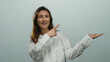 © Krakenimages.com - Woman smiling wearing white shirt posing isolated on white background pointing with hand while looking cheerful and confident, perfect for promotional content or business presentation.