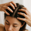 © Stella - Young woman massaging her scalp with both hands in gentle daylight