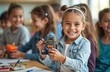 © Pete - Girl shows robot model at stem class. Kids build robots and learn about robotic engineering at school. Pupil holds toy and smiles in science lesson. Diverse students are happy studying technology.