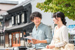 © buritora - A young couple looking at a guidebook and taking a city walk or sightseeing tour on a domestic trip