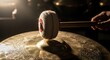 © ruangfootage - Close-up of a hand hitting a gong with a mallet