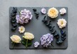 © Meow Creations - Floral flat lay with lavender hydrangea, cream roses, and eucalyptus on slate board.
