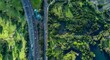 © Stefan - Aerial view of Western Springs Park, New Zealand, showcasing the juxtaposition of urban infrastructure and natural beauty. A busy highway runs alongside lush parkland.