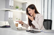 © Pichsakul - Asian business woman laugh point laptop screen happy online meeting presentation success professional modern office work environment desktop