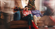© Malik25/peopleimages.com - Christmas, home and couple with stress, tired and exhausted with burnout, speed and headache. Xmas, man and woman on couch, tradition and tension with pressure, festive season and relationship