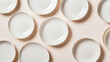 © photo for everything - Arrangement of minimalist white plates on a soft pink surface, casting subtle shadows. Clean, organized composition for a modern, understated tableware aesthetic.