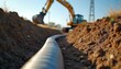 © Viktor - Underground cable installation involves excavating trench for infrastructure. Construction site shows yellow excavator, large cable. Project aims to connect power grid with renewable energy sources.