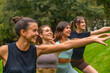 © unai - Young women enjoying yoga class in park