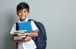 © Viktor - Smiling schoolboy holds books with backpack. Asian kid wears uniform with books going to school. Student is ready to learn, study and gain new knowledge in school years.