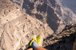 © Néstor - Resting hiker enjoying desert canyon view in oman