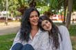 © Alejandro - Mother and daughter sharing a tender moment in the park