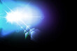 © Salindu - Blue and purple light flare with bright lens reflection glow isolated on black background