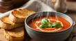 © Heshan - Delicious tomato soup with fresh basil and toasted bread is perfect for a comforting lunch or dinner