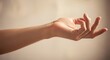 © Dulal - Closeup of a hand in a relaxed position, fingers slightly curled, against a soft backdrop