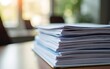 © wu - Close-Up View of Stacked Document Papers with Soft Focus and Warm Lighting in an Office Environment for Office Use and Organization Purposes. High quality